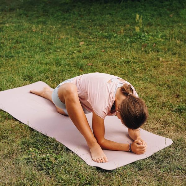 Person stretching gently outdoors, showing flexibility and peace.