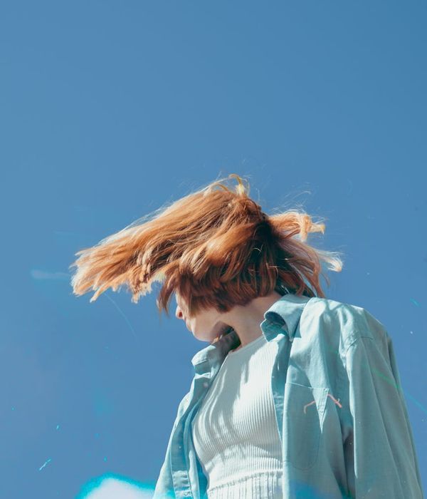 Woman feeling energetic and balanced in a bright, airy room.